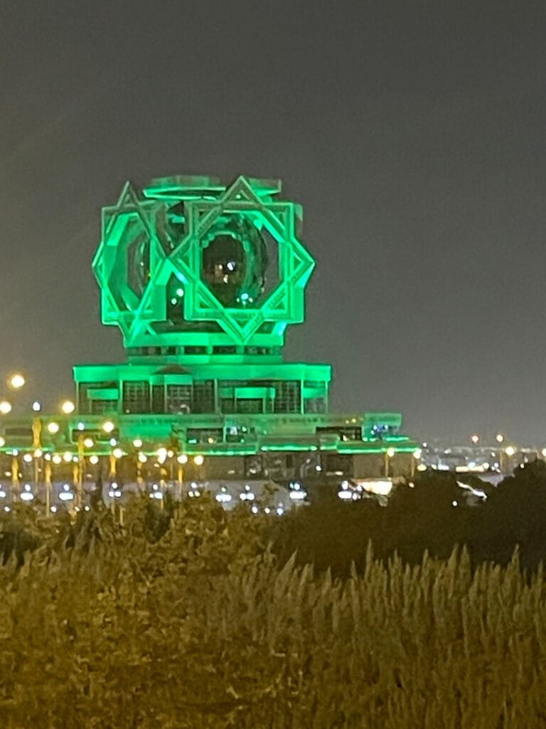 The wedding palace in Ashgabat, Turkmenistan's capital, lit up green at night.