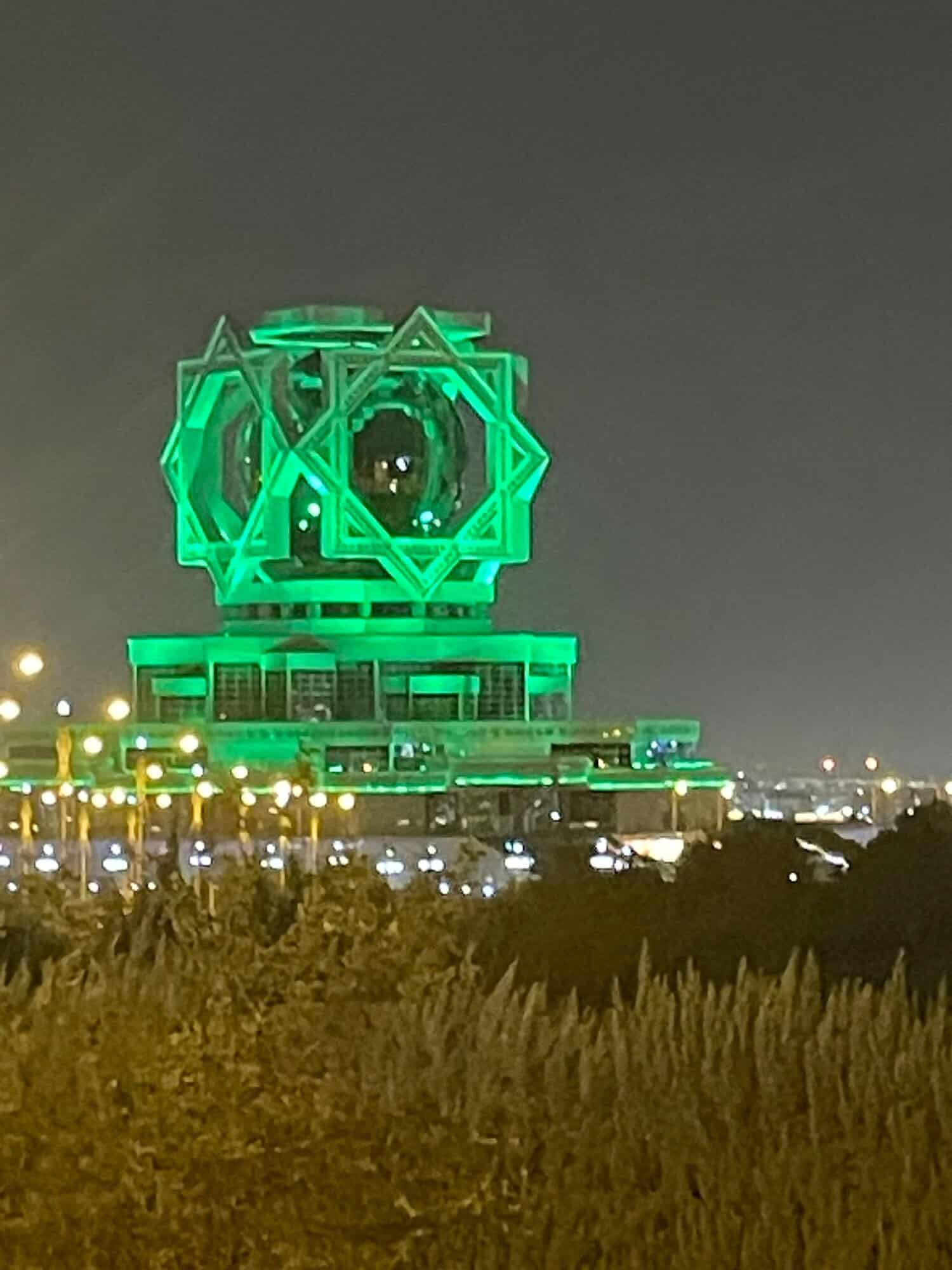 The wedding palace in Ashgabat, Turkmenistan's capital, lit up green at night.